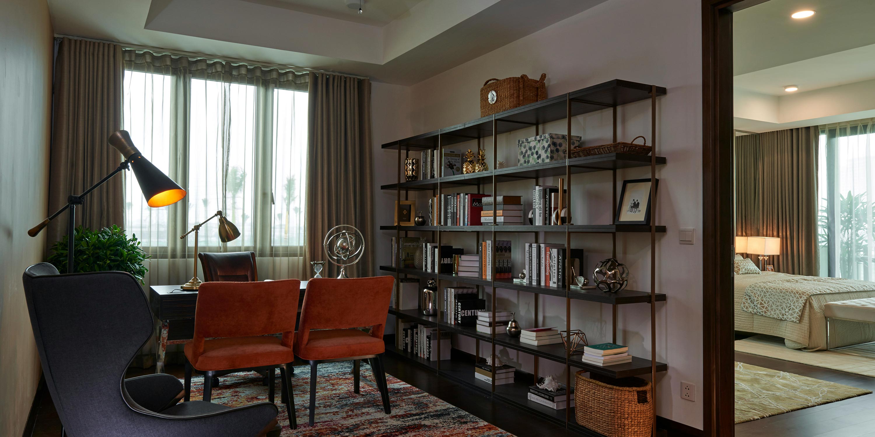 Cozy home office with bookshelves and a reading lamp.