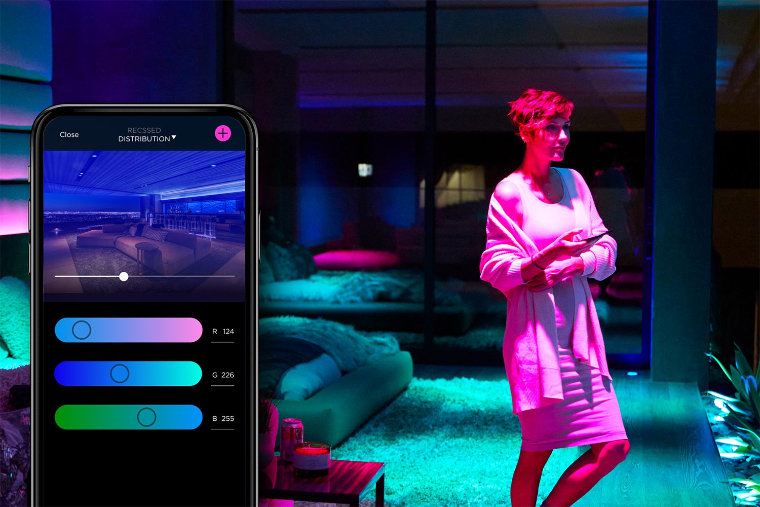 Woman in a smart home environment with mood lighting controlled via app