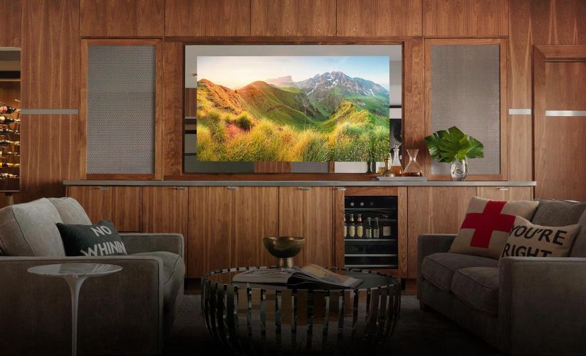 A stylish bar area with a hidden Seura mirror TV, surrounded by warm wooden paneling.