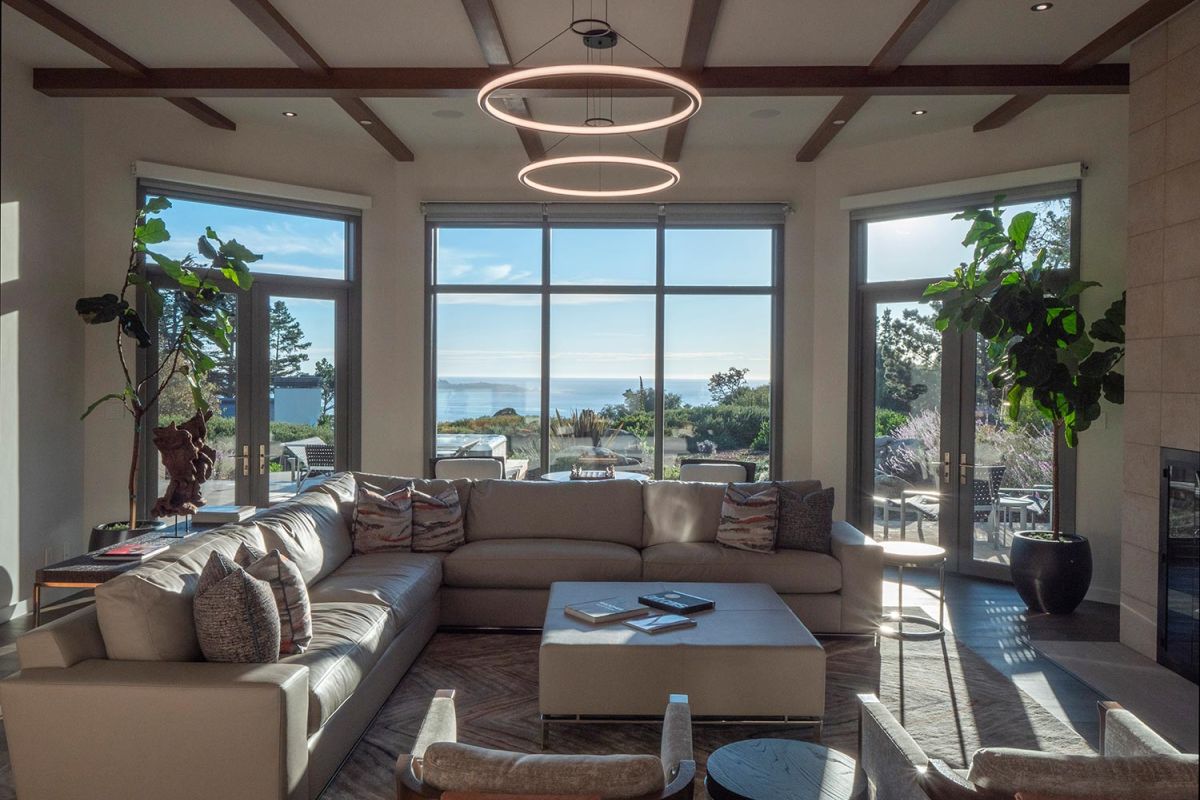 Spacious modern living room with ocean view and circular ceiling light