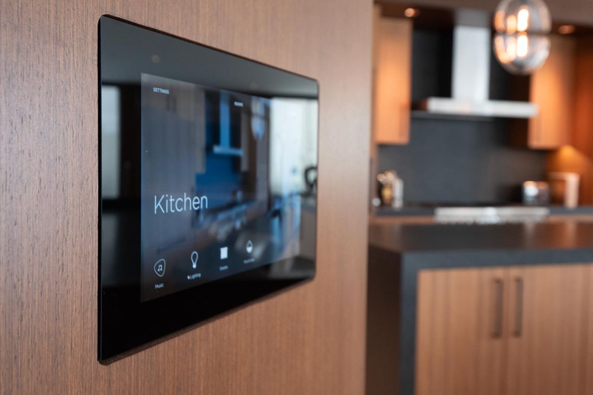 Smart home wall panel with kitchen controls in modern wood-paneled wall