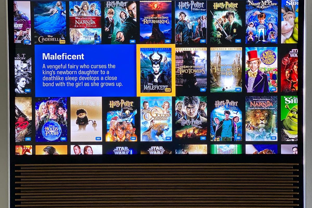 Close-up of a TV screen showing movie selection with Maleficent highlighted