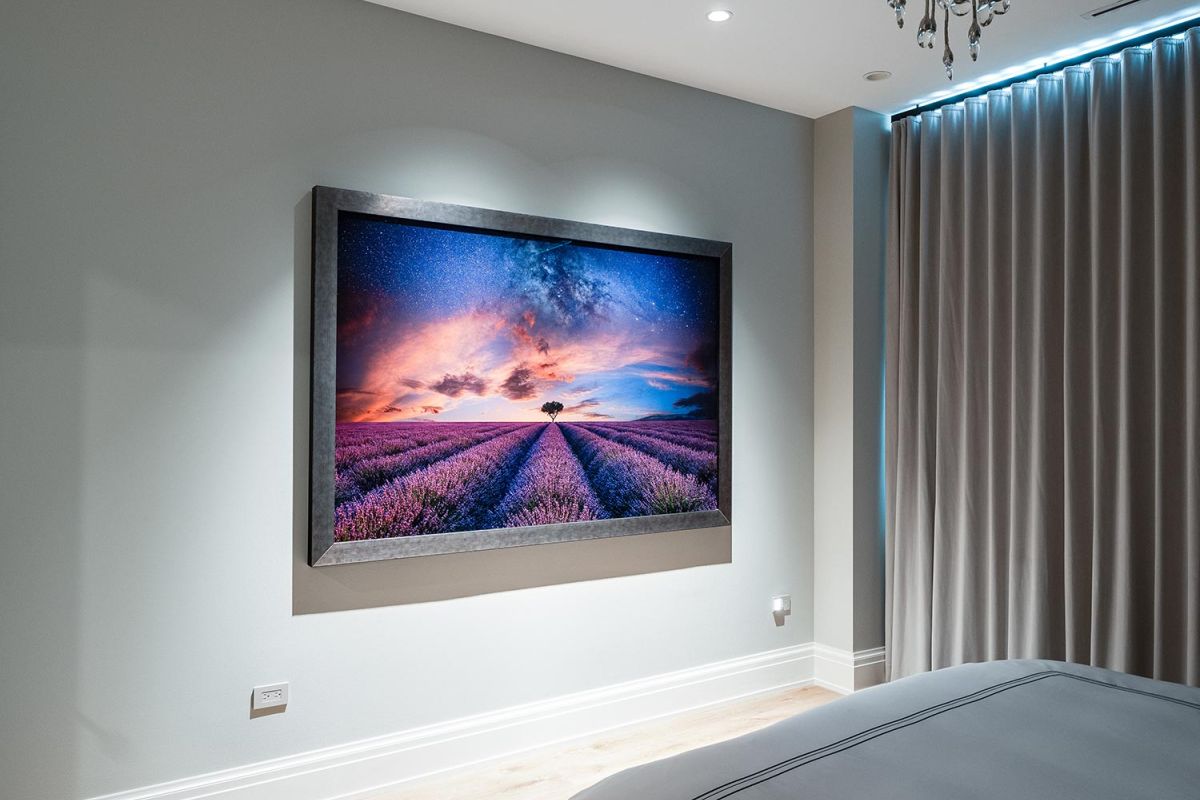 Framed digital artwork of lavender field at sunset displayed in bedroom